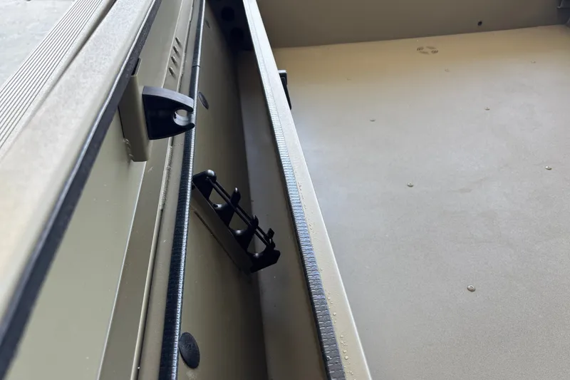 Slide: The Image of Interior view of 2027 Tracker Grizzly 1654 T Sportsman boat, showcasing storage compartment details. - 18
