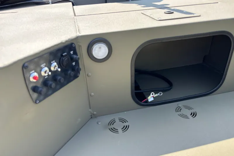 Slide: The Image of Control panel of 2027 Tracker Grizzly 1654 T Sportsman boat, featuring switches and wiring. - 14