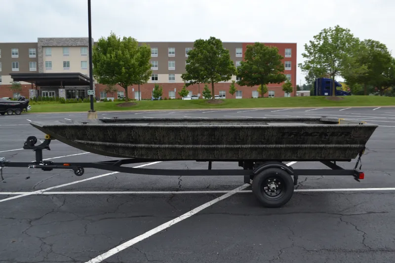 The Image of 2027 Tracker Grizzly 1648 Utility boat on trailer in parking lot. - 0