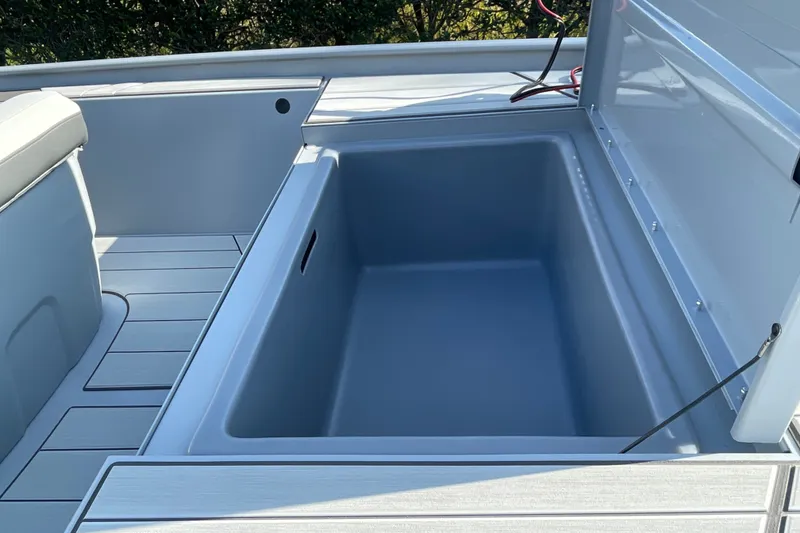 Slide: The Image of 2027 Tracker Bass Tracker Classic CC boat storage compartment, open and empty. - 13