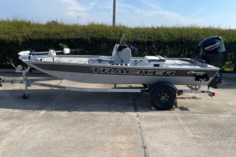 The Image of 2027 Tracker Bass Tracker Classic CC boat on trailer, parked outdoors. - 0