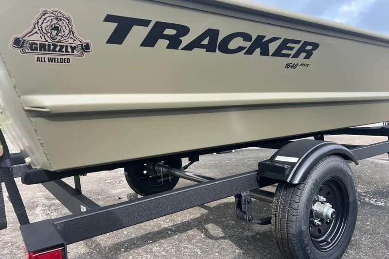 The Image of 2027 Tracker Grizzly 1648 Utility boat on trailer, featuring all-welded design. - 0