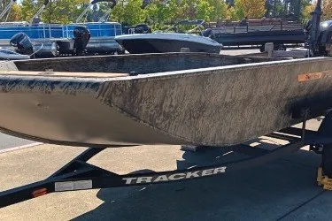 The Image of 2027 Tracker Grizzly 1553 Timber boat on trailer, parked outdoors. - 0