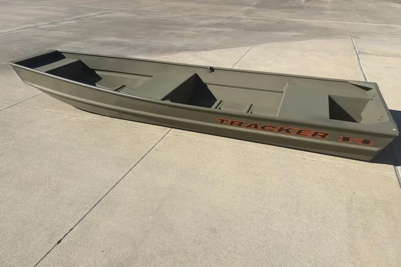 The Image of 2027 Tracker Grizzly 14 Jon boat on concrete surface, showcasing its durable design. - 0