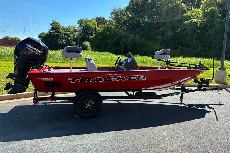 The Image of 2027 Tracker Pro Team 175 boat with Mercury engine on a trailer, parked outdoors. - 0
