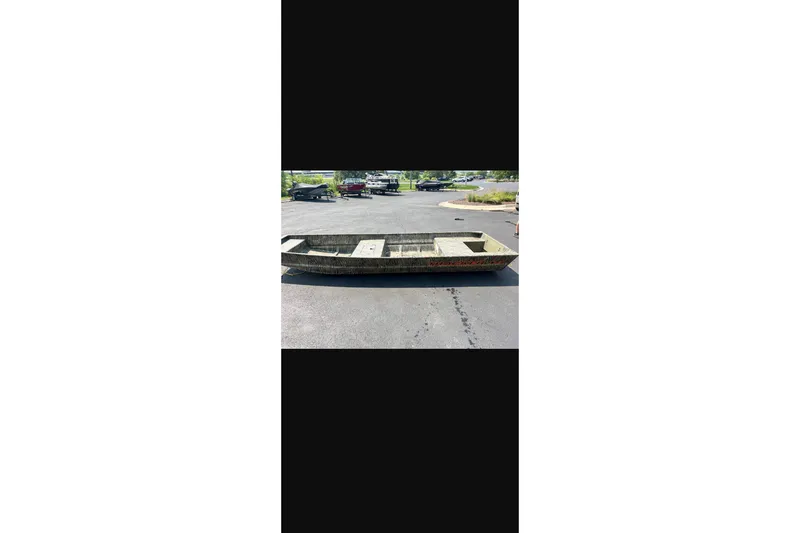 The Image of 2027 Tracker Grizzly 15 Jon boat on pavement, ideal for fishing and outdoor adventures. - 0