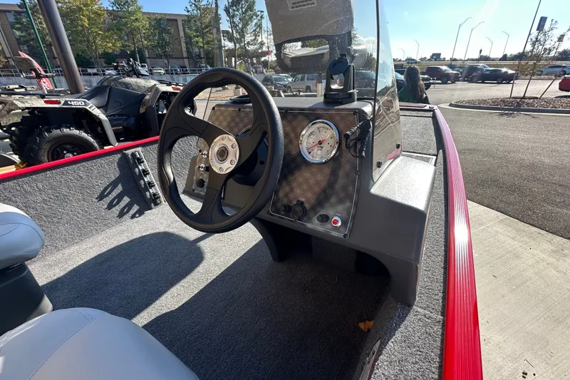Slide: The Image of 2027 Tracker Bass Tracker Classic XL boat dashboard with steering wheel and gauge. - 58