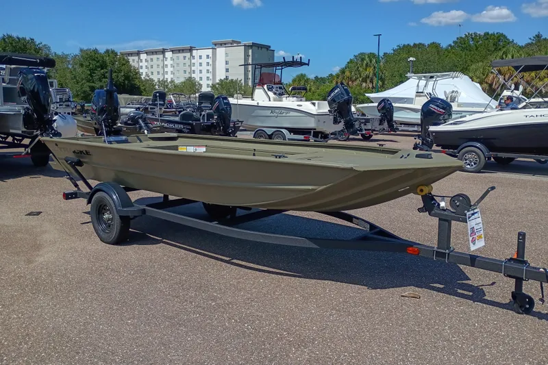 The Image of 2027 Tracker Grizzly 1654 T Sportsman boat on trailer in outdoor showroom. - 0