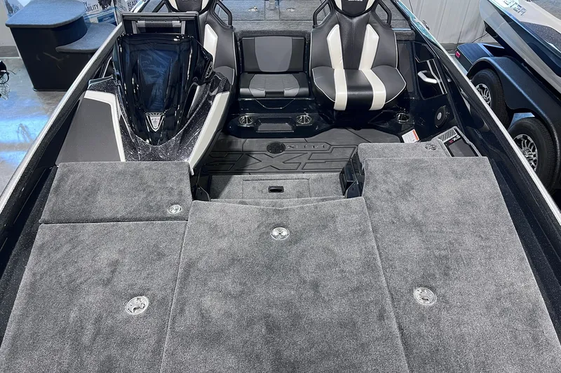 Slide: The Image of 2026 Skeeter FXR20 boat interior with gray carpet and dual seating arrangement. - 6