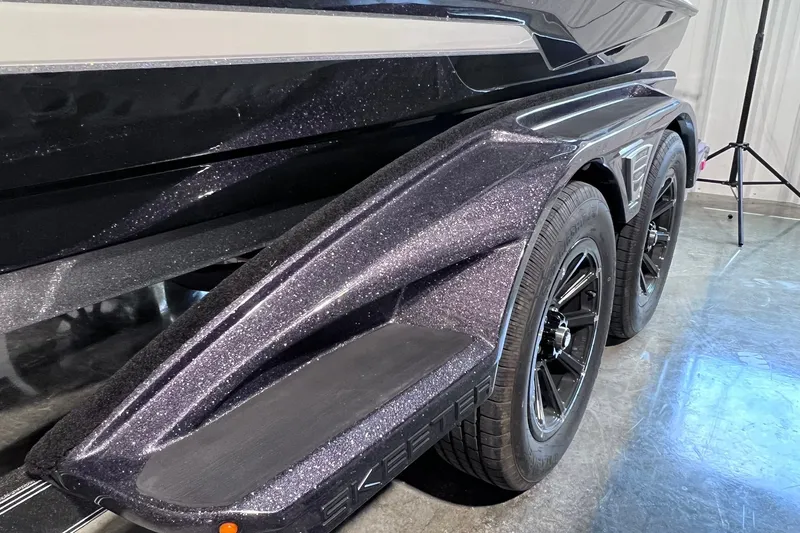 Slide: The Image of 2026 Skeeter FXR20 boat trailer with sleek black design and dual wheels. - 16