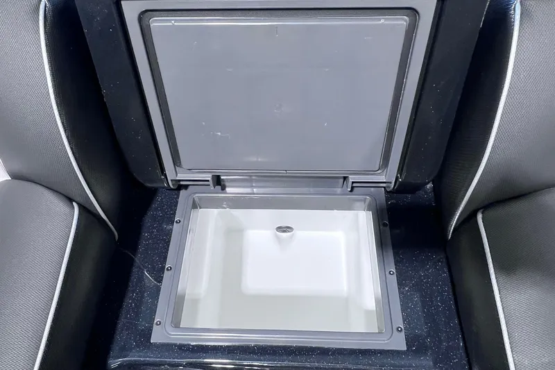 Slide: The Image of 2026 Skeeter FXR20 boat storage compartment with open lid, showcasing interior space. - 11