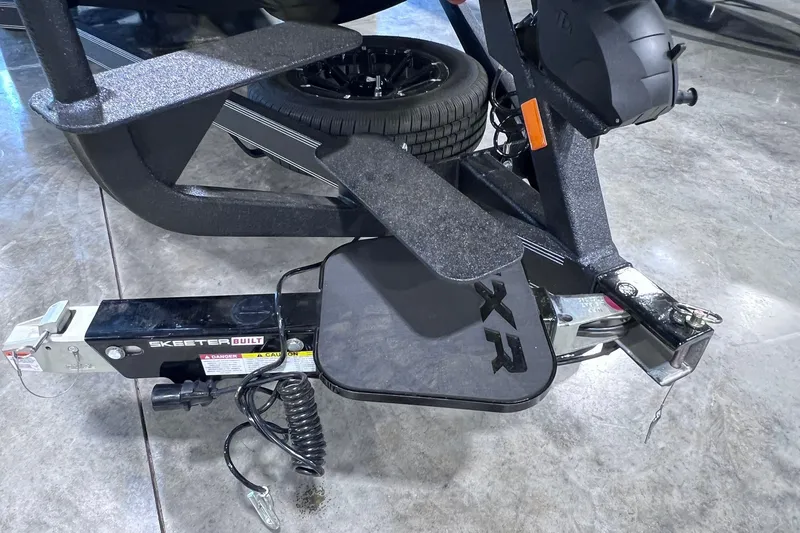 Slide: The Image of 2026 Skeeter FXR20 boat trailer hitch with XR branding on a concrete floor. - 18