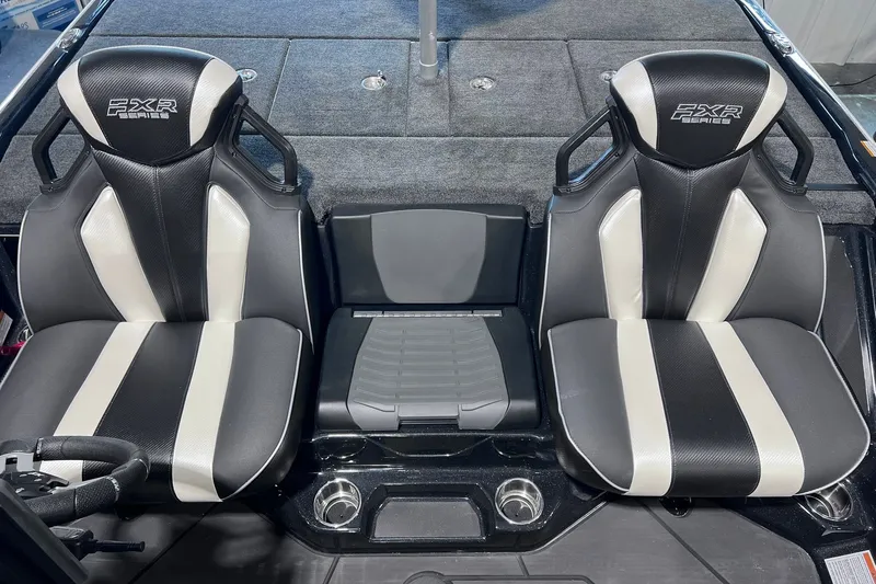 Slide: The Image of 2026 Skeeter FXR20 boat seats with black and white design, featuring cup holders. - 7