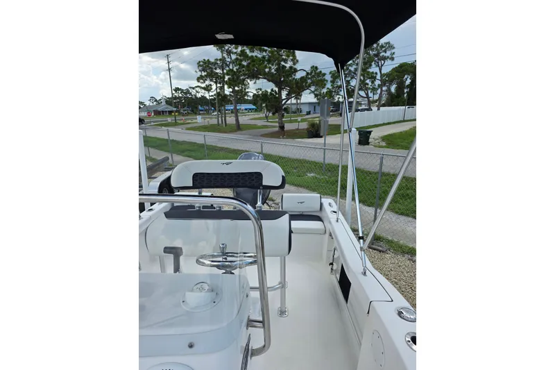 Slide: The Image of 2024 Tidewater 180 CC Adventure boat interior with steering wheel and seating. - 12