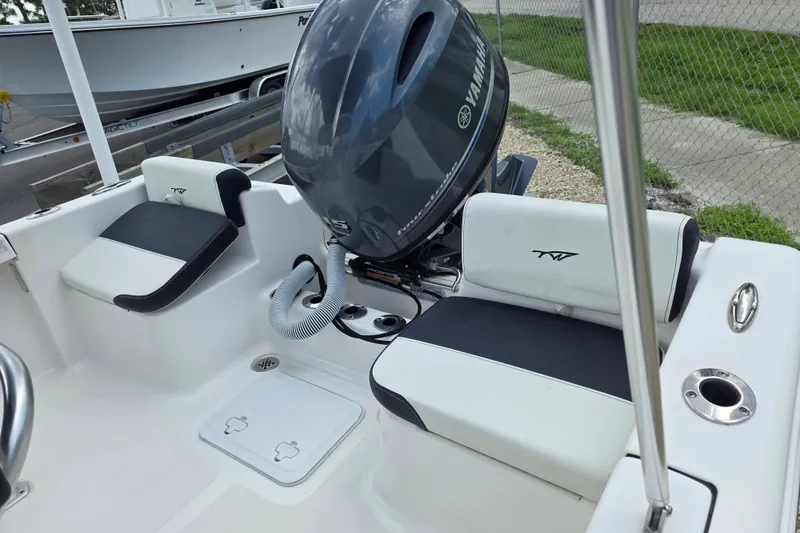 Slide: The Image of 2024 Tidewater 180 CC Adventure boat interior with Yamaha engine, featuring cushioned seating. - 4