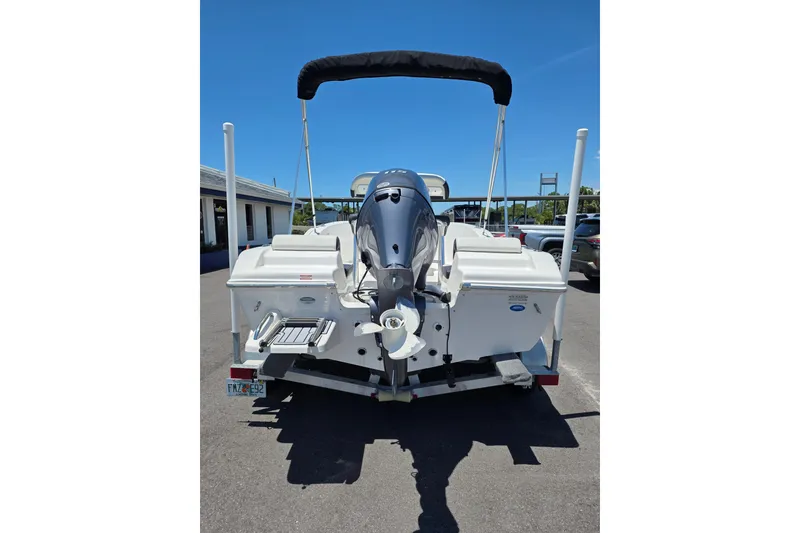 Slide: The Image of 2024 Tidewater 180 CC Adventure boat, rear view with outboard motor and bimini top. - 3