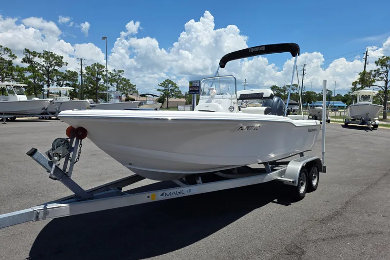 Slide: The Image of 2024 Tidewater 180 CC Adventure boat on trailer under clear blue sky. - 2