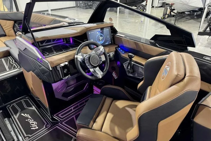 Slide: The Image of Interior of a 2027 Tigé 25ZX boat with modern dashboard and leather seating. - 16