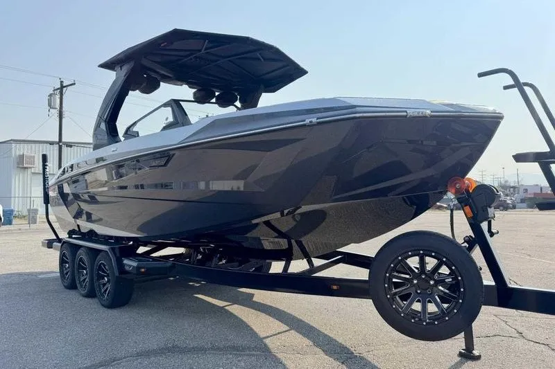 Slide: The Image of 2027 Tigé 25ZX boat on trailer, sleek design, parked outdoors. - 13