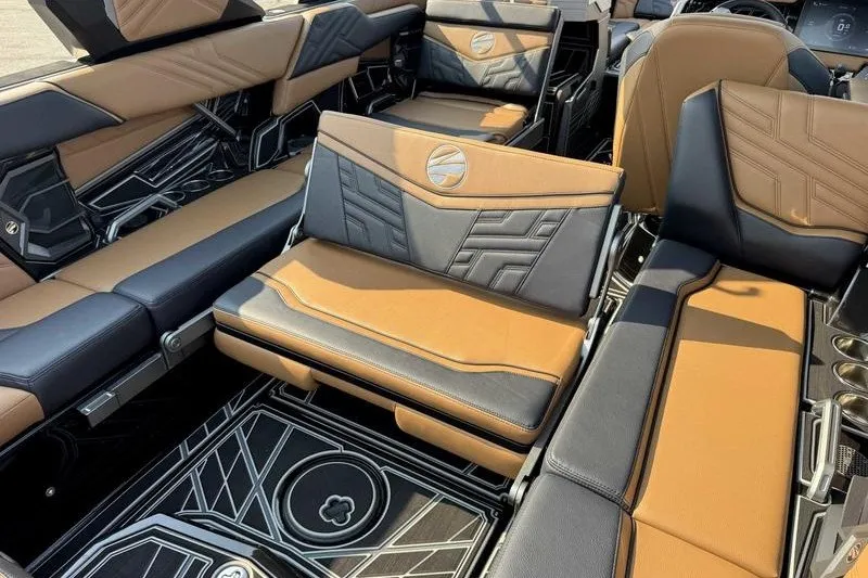 Slide: The Image of 2027 Tigé 25ZX boat interior with luxurious brown and black seating and modern design. - 1