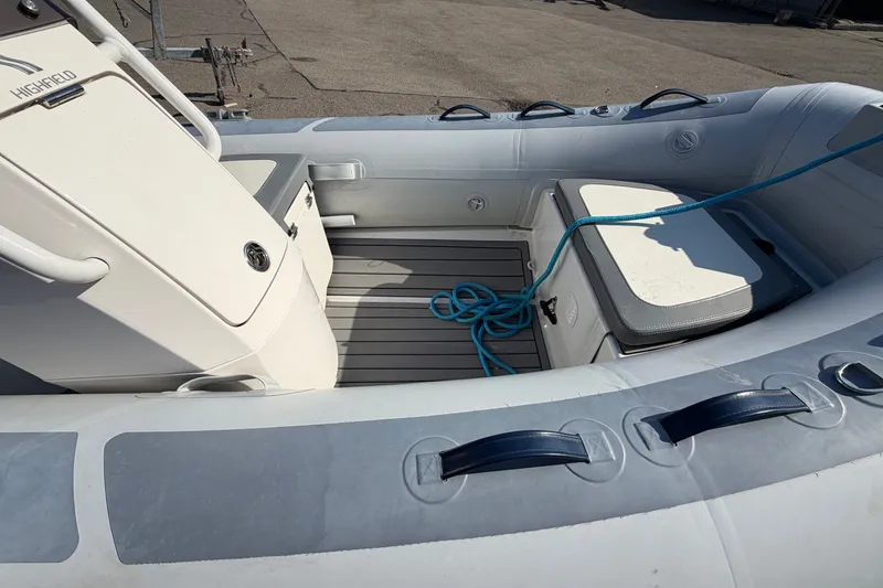 Slide: The Image of 2025 Highfield Classic 380 FCT boat interior with seating and storage compartments. - 2