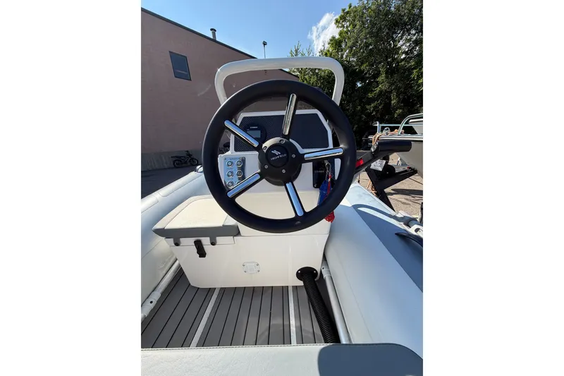 Slide: The Image of 2025 Highfield Classic 380 FCT boat steering console with modern controls and sleek design. - 6