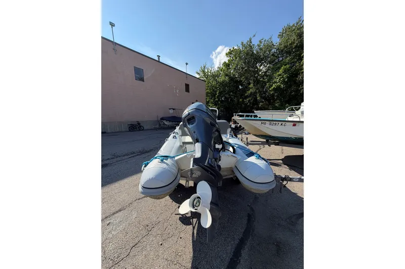 Slide: The Image of 2025 Highfield Classic 380 FCT boat parked outdoors, showcasing rear view and motor. - 4