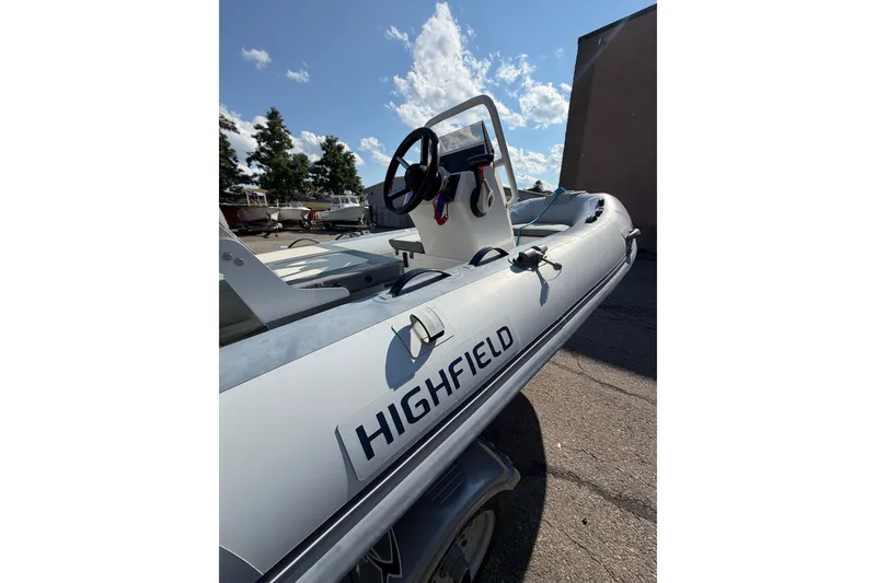 Slide: The Image of 2025 Highfield Classic 380 FCT inflatable boat under a clear blue sky. - 7