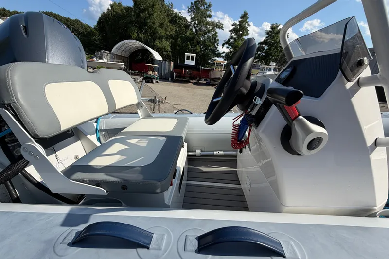Slide: The Image of 2025 Highfield Classic 380 FCT boat interior with steering wheel and seating. - 3
