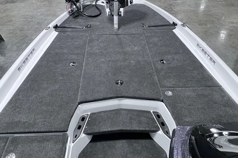 Slide: The Image of 2026 Skeeter ZXR20 SE boat deck with gray carpeting and storage compartments. - 4