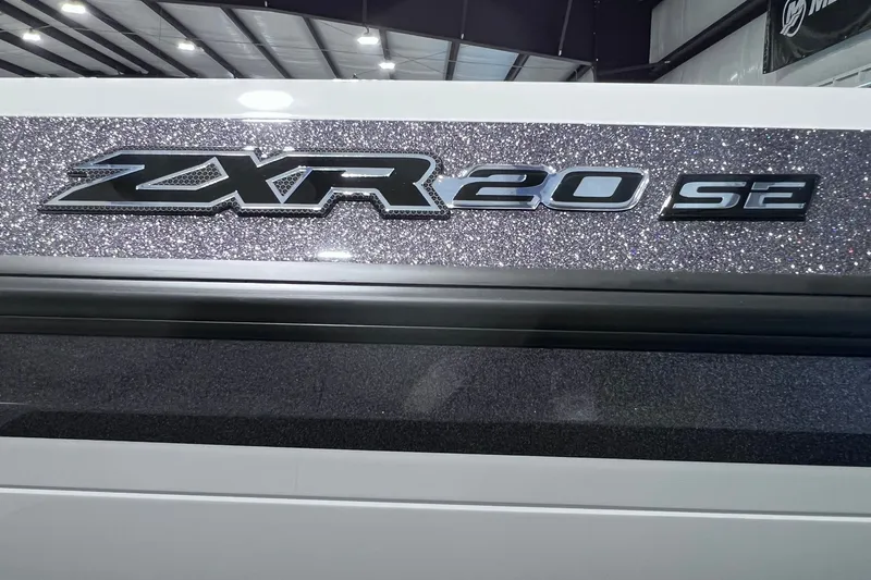Slide: The Image of 2026 Skeeter ZXR20 SE logo on a glittery surface in a showroom. - 2