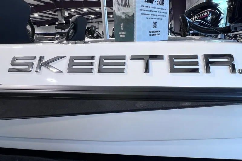 Slide: The Image of 2026 Skeeter ZXR20 SE boat with sleek metallic logo in showroom. - 3
