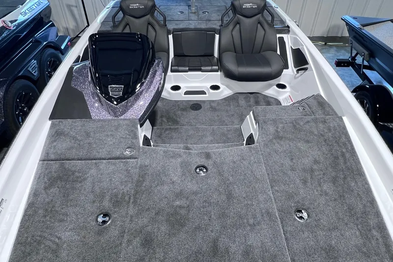 Slide: The Image of 2026 Skeeter ZXR20 SE boat interior with gray carpet and sleek seating design. - 6