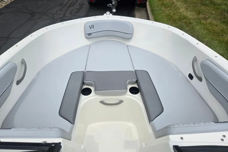 Slide: The Image of 2022 Bayliner VR4 Bowrider I/O boat interior with gray seating and cup holders. - 16