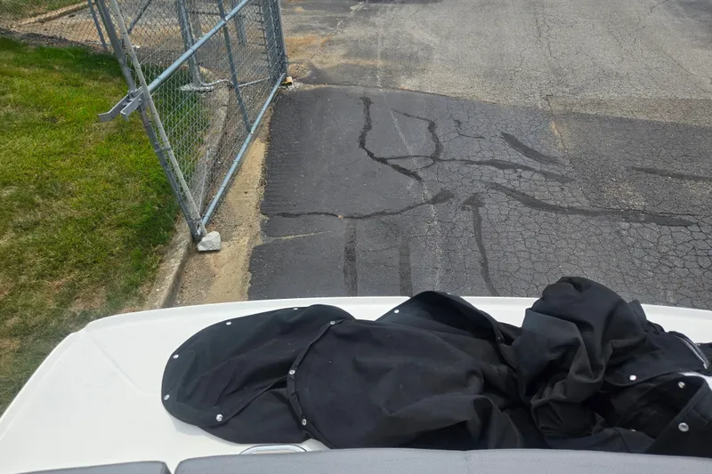 Slide: The Image of 2022 Bayliner VR4 Bowrider I/O parked near a chain-link gate on cracked pavement. - 24