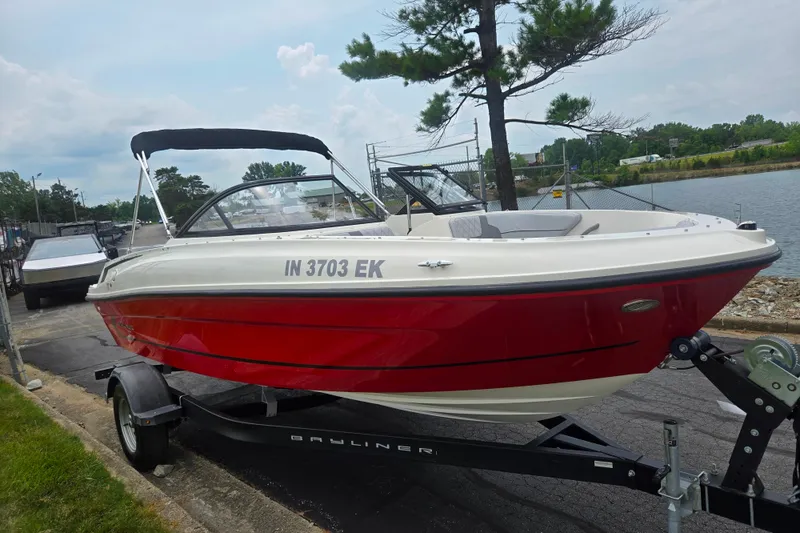Slide: The Image of 2022 Bayliner VR4 Bowrider I/O boat on trailer by a lakeside. - 8