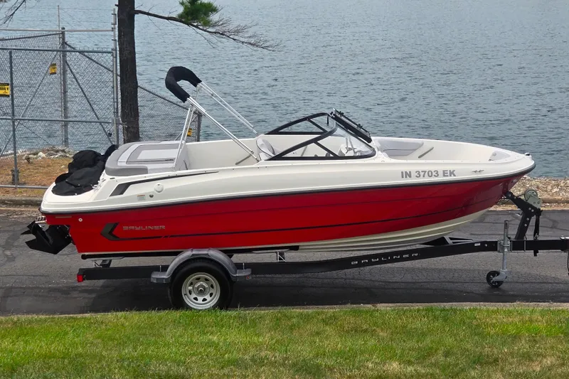 The Image of 2022 Bayliner VR4 Bowrider I/O boat on trailer by a lake. - 0