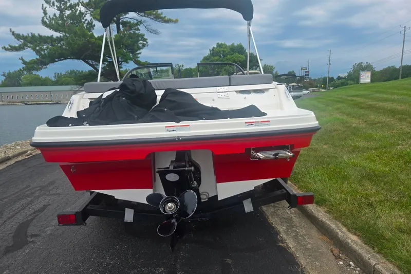 Slide: The Image of 2022 Bayliner VR4 Bowrider I/O boat on trailer, rear view, red and white design. - 2