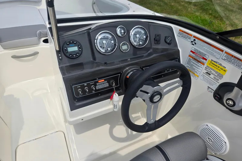 Slide: The Image of 2022 Bayliner VR4 Bowrider I/O dashboard with steering wheel and control panel. - 13