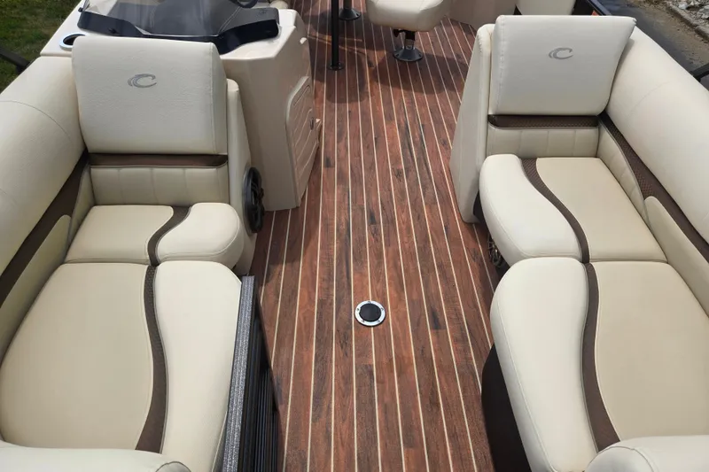 Slide: The Image of Luxurious interior of 2016 Crest Classic 230 Chateau pontoon boat with plush seating and wood flooring. - 11