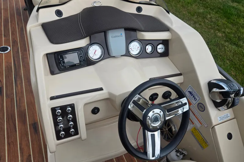 Slide: The Image of Steering console of 2016 Crest Classic 230 Chateau boat with gauges and controls. - 25