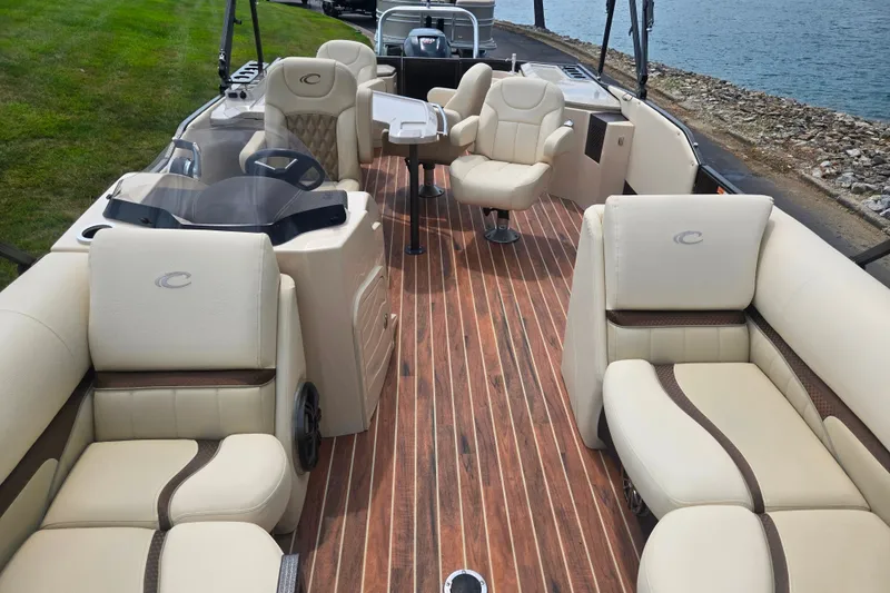 Slide: The Image of Luxurious 2016 Crest Classic 230 Chateau pontoon boat with elegant seating and wooden deck. - 12