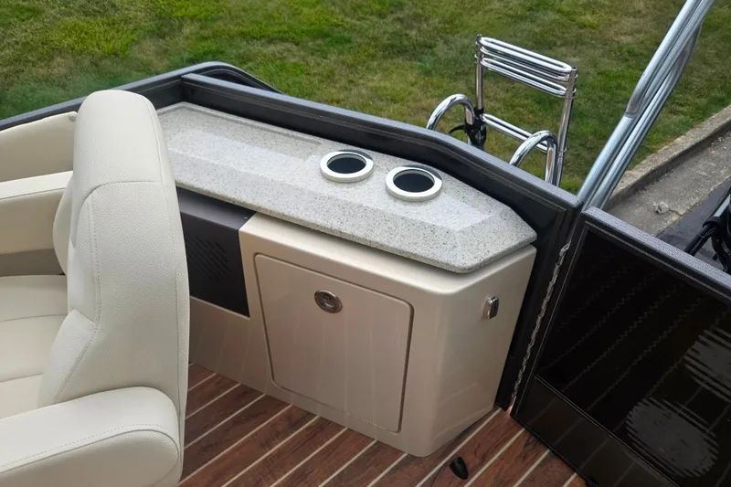 Slide: The Image of 2016 Crest Classic 230 Chateau boat interior with seating and storage area. - 18