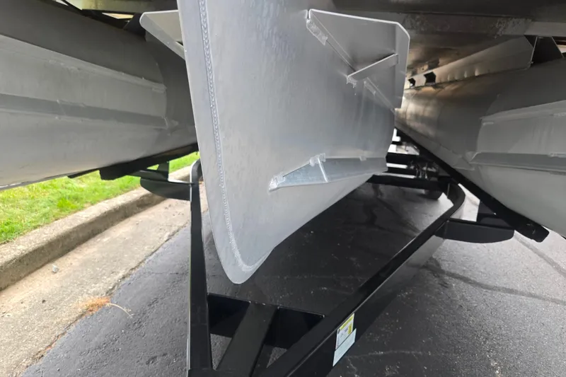 Slide: The Image of Underneath view of a 2016 Crest Classic 230 Chateau pontoon boat on a trailer. - 7