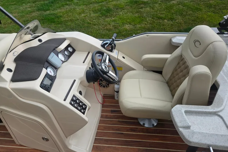 Slide: The Image of Luxurious 2016 Crest Classic 230 Chateau boat interior with plush captain's chair and modern dashboard. - 24