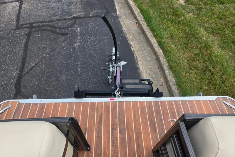 Slide: The Image of 2016 Crest Classic 230 Chateau boat trailer hitch on wooden deck, parked on asphalt. - 28