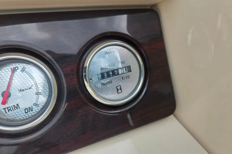 Slide: The Image of Dashboard gauges of a 2016 Crest Classic 230 Chateau boat, showing trim and hours. - 26