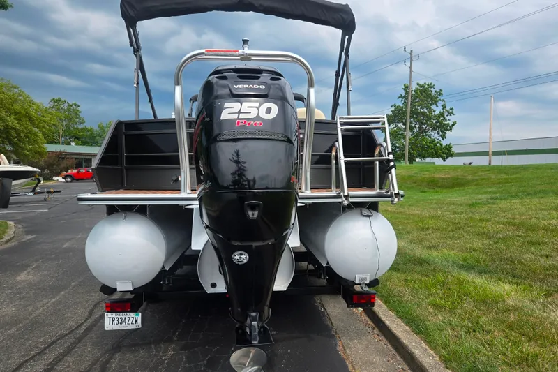 Slide: The Image of 2016 Crest Classic 230 Chateau boat with powerful 250 Pro Verado engine, parked outdoors. - 2