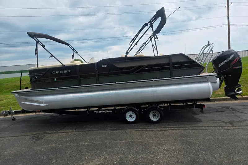 Slide: The Image of 2016 Crest Classic 230 Chateau pontoon boat on trailer, featuring a Mercury outboard motor. - 4