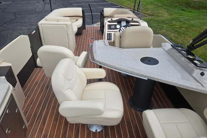 Slide: The Image of Interior of 2016 Crest Classic 230 Chateau pontoon boat with beige seating and wood flooring. - 21